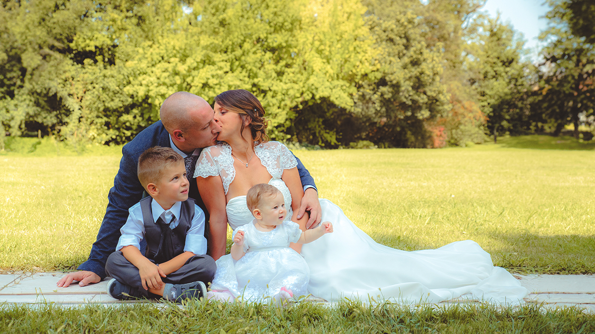 Immagine di due sposi seduti su un prato con i loro figli, foto di Ferruccio Munzittu